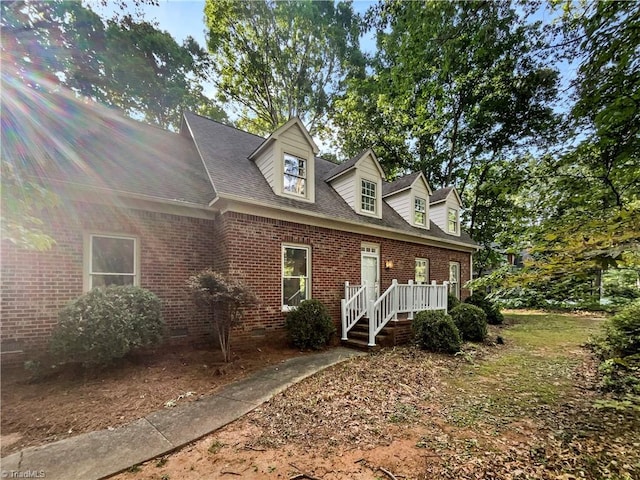5605 Southstone Dr, Greensboro, NC 27406 - cape cod home featuring brick siding, crawl space, and roof with shingles