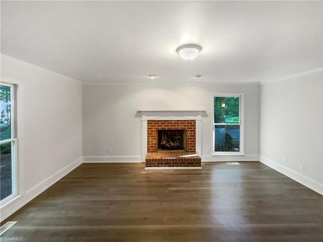 5605 Southstone Dr, Greensboro, NC 27406 - unfurnished living room with ornamental molding, wood finished floors, baseboards, and a brick fireplace