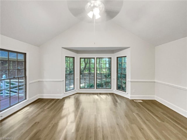 5605 Southstone Dr, Greensboro, NC 27406 - unfurnished room with a ceiling fan, wood finished floors, vaulted ceiling, baseboards, and healthy amount of natural light