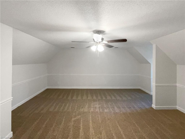 5605 Southstone Dr, Greensboro, NC 27406 - bonus room featuring carpet, lofted ceiling, baseboards, a ceiling fan, and a textured ceiling