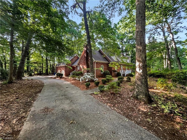 5605 Southstone Dr, Greensboro, NC 27406 - view of property exterior with brick siding and asphalt driveway