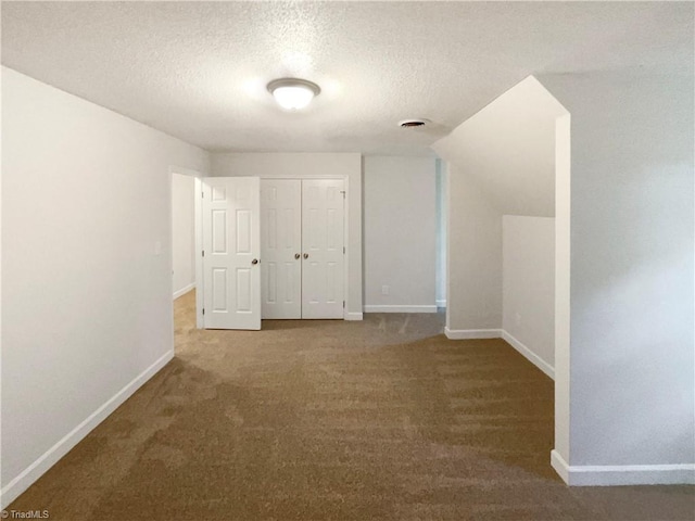 5605 Southstone Dr, Greensboro, NC 27406 - unfurnished bedroom with a textured ceiling, baseboards, a closet, and carpet