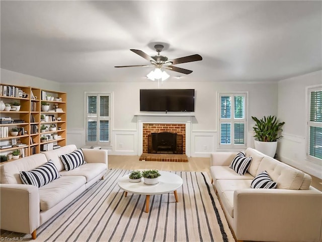 5605 Southstone Dr, Greensboro, NC 27406 - living area with ceiling fan, a brick fireplace, and a decorative wall