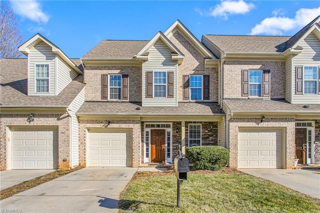 multi unit property featuring a garage and a front lawn