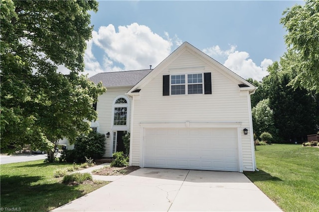 traditional home with a front yard, a garage, and concrete driveway