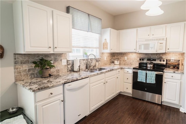 kitchen with white appliances, a sink, dark wood finished floors, tasteful backsplash, and white cabinetry