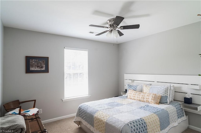 carpeted bedroom with baseboards and a ceiling fan
