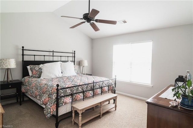 bedroom with vaulted ceiling, light carpet, baseboards, and a ceiling fan