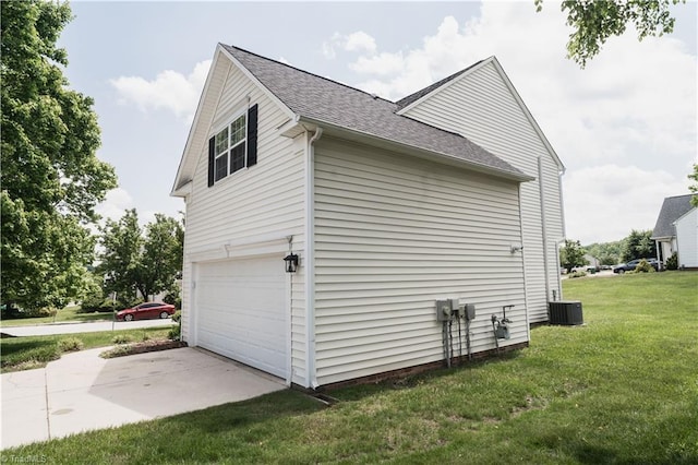view of side of property featuring a garage, a lawn, roof with shingles, cooling unit, and concrete driveway