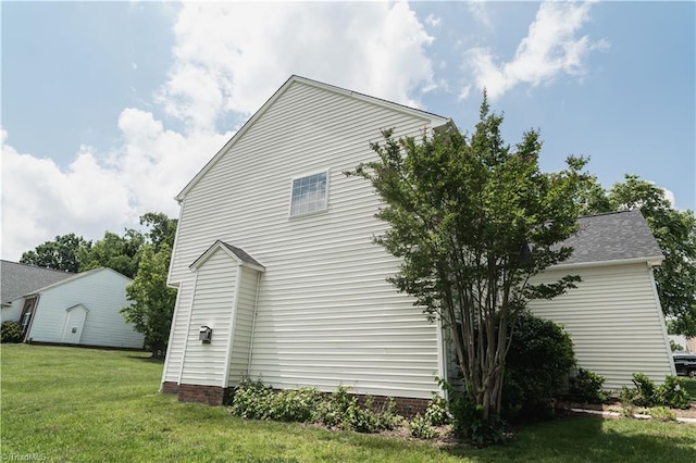 view of home's exterior with a yard