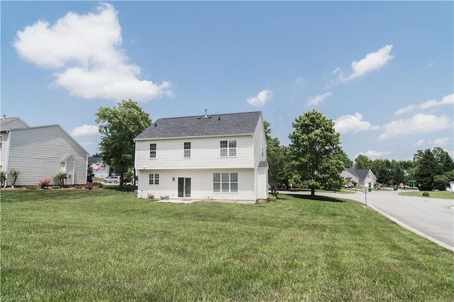rear view of property with a lawn