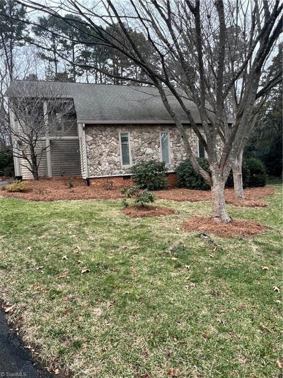 view of side of property featuring a yard