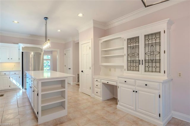 kitchen with white cabinets, built in study area, open shelves, light countertops, and a kitchen island