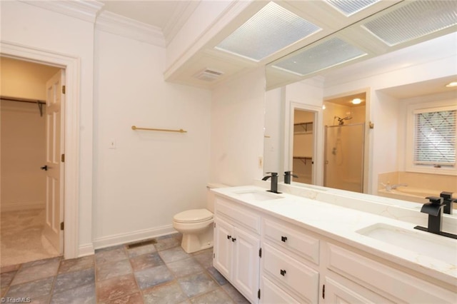 bathroom featuring stone finish floor, a shower stall, toilet, and a sink