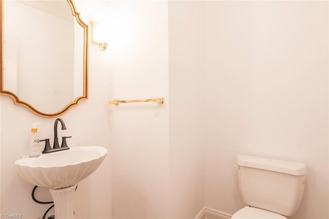 half bathroom featuring toilet