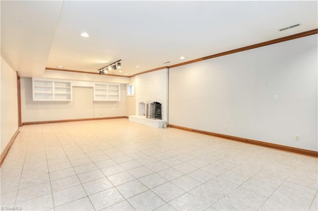 interior space featuring baseboards, a fireplace, and crown molding
