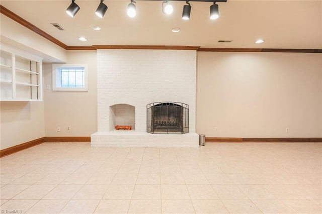 unfurnished living room featuring baseboards, visible vents, a fireplace, and ornamental molding