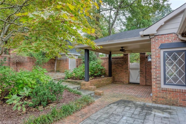 view of yard with fence and a ceiling fan