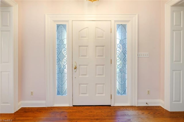 entrance foyer featuring baseboards and wood finished floors
