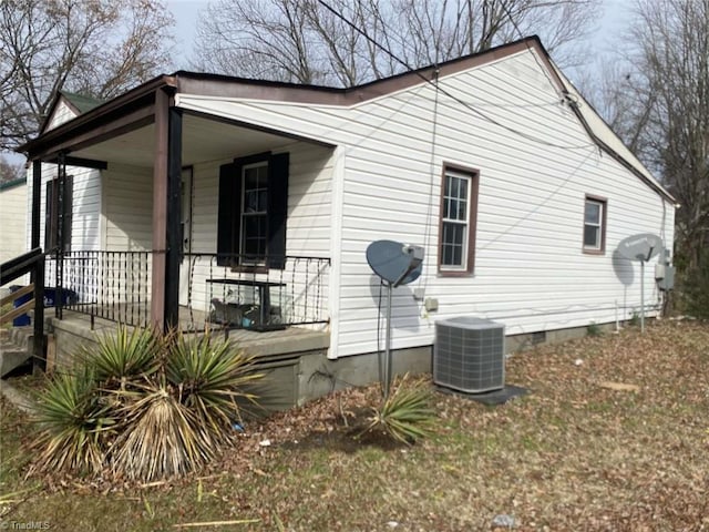 view of home's exterior with a porch and cooling unit