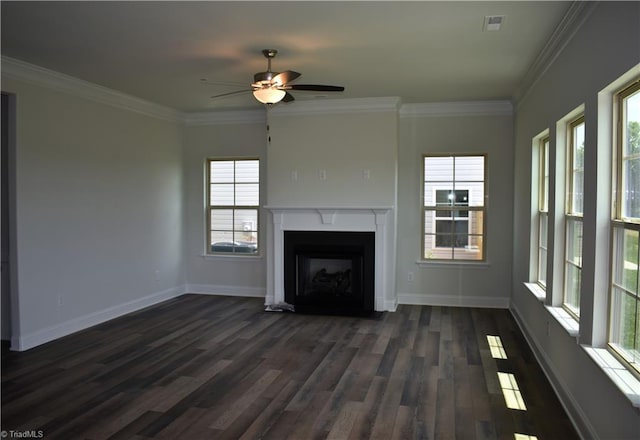 unfurnished living room with plenty of natural light, dark hardwood / wood-style floors, crown molding, and ceiling fan