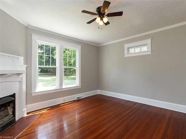 unfurnished living room with dark hardwood / wood-style floors, ceiling fan, and ornamental molding