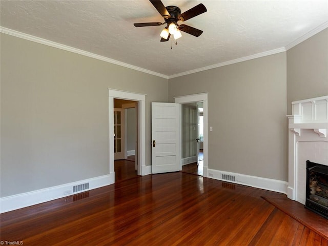 unfurnished living room featuring hardwood / wood-style flooring, ceiling fan, and ornamental molding