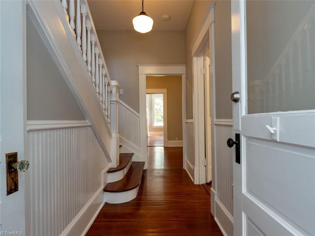 corridor with dark hardwood / wood-style flooring