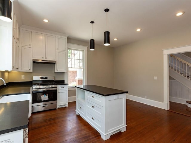 kitchen featuring white cabinets, a center island, pendant lighting, and stainless steel range with gas stovetop