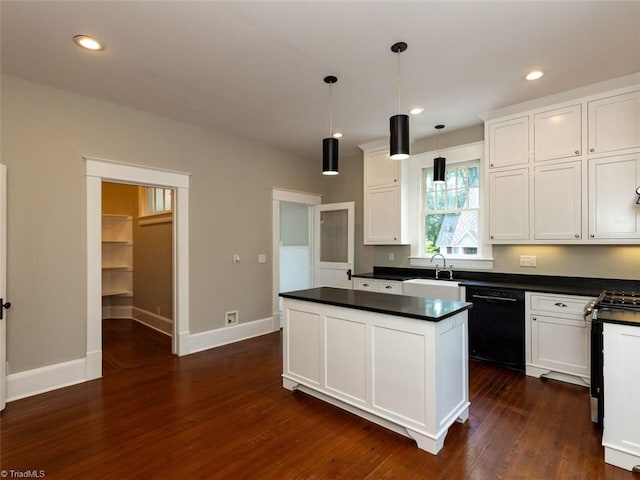 kitchen featuring pendant lighting, dark wood-type flooring, sink, black dishwasher, and white cabinetry