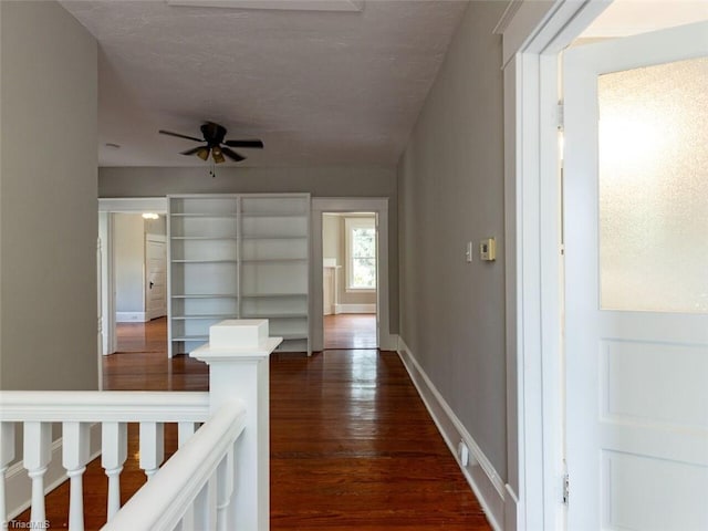 corridor with dark hardwood / wood-style flooring