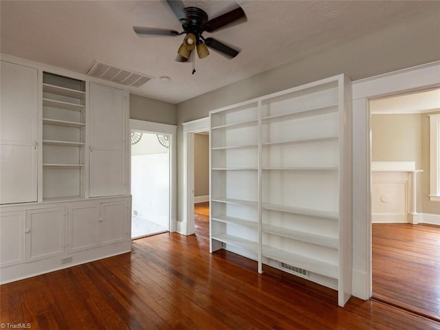 spare room with dark hardwood / wood-style floors and ceiling fan