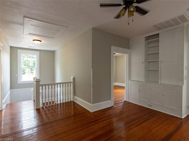 empty room with hardwood / wood-style floors and ceiling fan