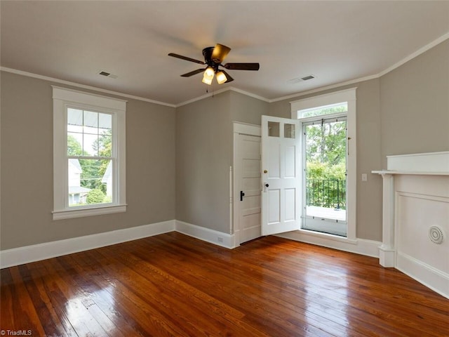 entryway featuring a healthy amount of sunlight, crown molding, and wood-type flooring