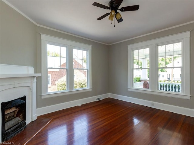 unfurnished living room featuring ceiling fan, dark hardwood / wood-style flooring, and ornamental molding