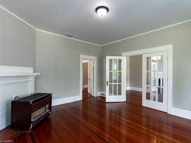 unfurnished living room with french doors, dark hardwood / wood-style floors, and ornamental molding