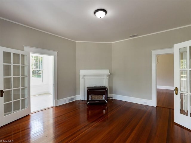 unfurnished living room featuring crown molding, french doors, and hardwood / wood-style flooring