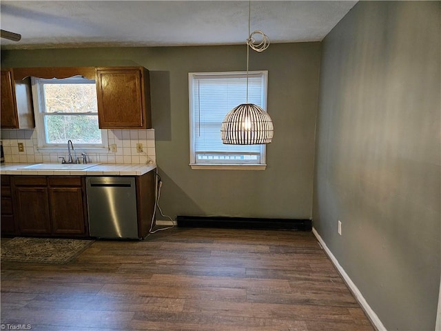 kitchen featuring sink, dishwasher, decorative backsplash, decorative light fixtures, and tile countertops