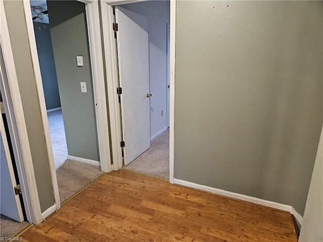 hallway with light hardwood / wood-style floors