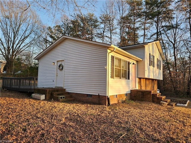 view of home's exterior with a wooden deck