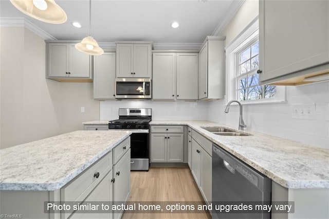 kitchen with gray cabinets, stainless steel appliances, hanging light fixtures, and sink