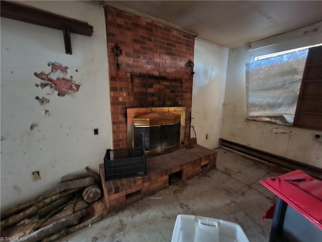 unfurnished living room with a fireplace and baseboard heating