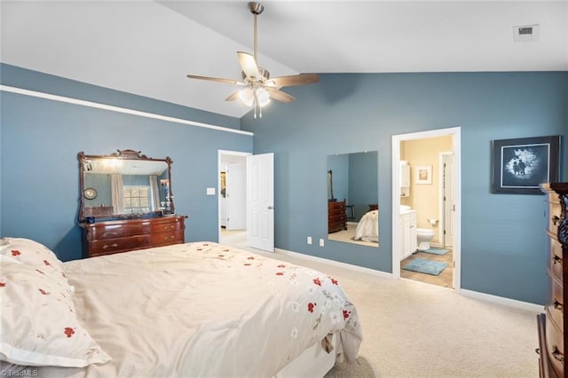 carpeted bedroom featuring ceiling fan, lofted ceiling, and ensuite bath