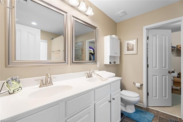 bathroom featuring tile patterned flooring, vanity, and toilet