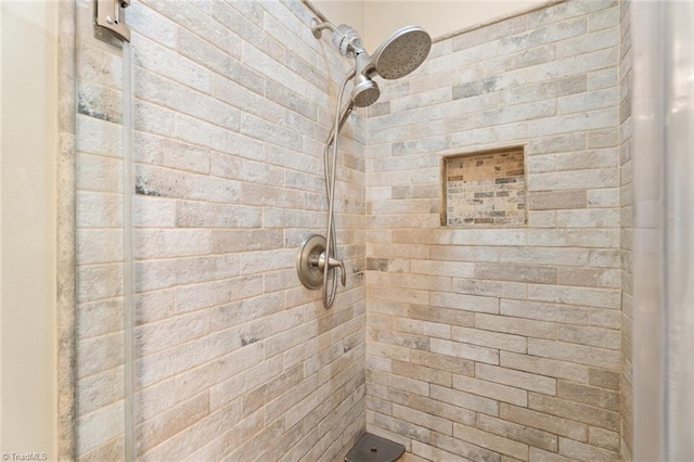 bathroom with a tile shower