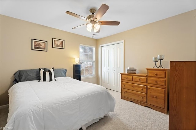 bedroom with ceiling fan, carpet floors, and a closet