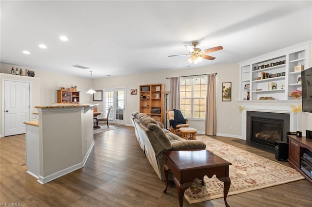 living room featuring dark hardwood / wood-style floors and ceiling fan