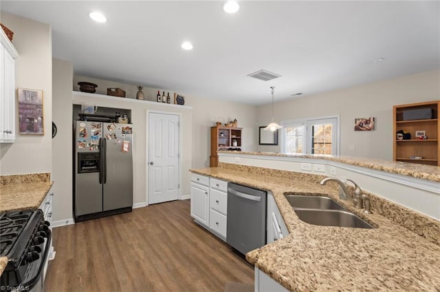 kitchen featuring sink, hanging light fixtures, dark hardwood / wood-style flooring, white cabinets, and appliances with stainless steel finishes