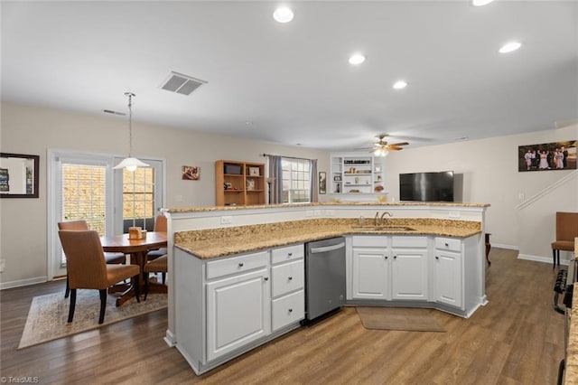 kitchen featuring a healthy amount of sunlight, dishwasher, white cabinets, and hanging light fixtures