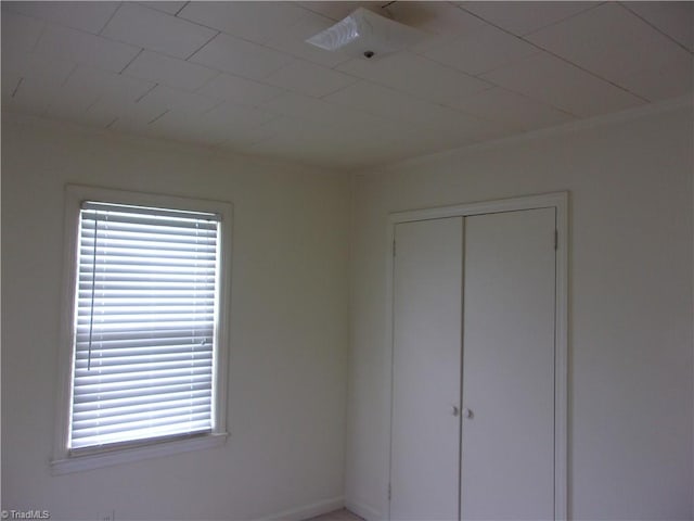 unfurnished bedroom with a closet, multiple windows, and ceiling fan